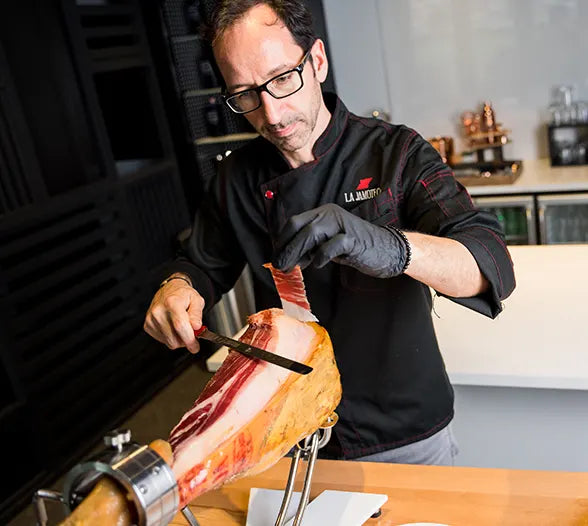 Chef slicing Jamón Ibérico at La Jamoteca in Miami